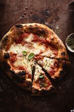 Sliced Homemade Pizza Margherita On A Dark Surface