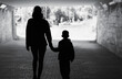 © kieferpix - silhouette of mother and child walking in the city