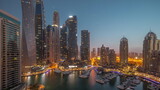 Fototapeta Nowy Jork - Dubai marina tallest skyscrapers and yachts in harbor aerial night to day timelapse.
