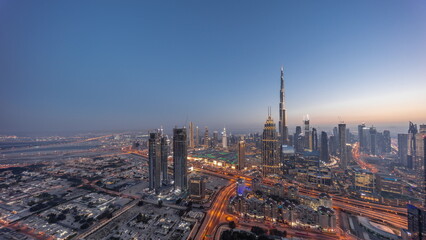  Aerial view of tallest towers in Dubai Downtown skyline and highway day to night timelapse.
