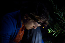A Man Cooks Dinner With The Illumination From His Headlamp In Wawona, California.