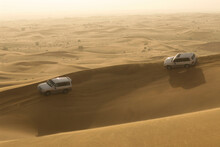 Four Wheel Drive Vehicles Negotiate Sand Dunes  During A Desert Driving Safari In The Dunes Outside Of Dubai