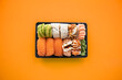Top view of take away sushi package isolated on coloful background