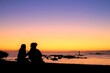 © 百合 須藤 - silhouette of a couple at sunset beach