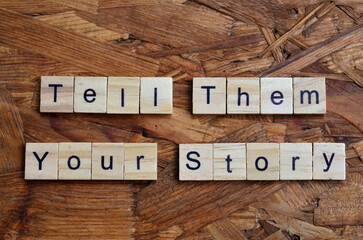 tell them your story text on wooden square, business motivation quotes