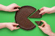 Leinwandbild Motiv Pie chart concept, people sharing chocolate cake, above view on a green background.
