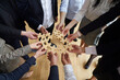 © Studio Romantic - Hands of office workers man and woman in business clothes with puzzle pieces symbolize team building and ability to work together to achieve company goals or corporate partnerships standing indoors