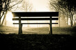 silhouette of an empty bench in a park 