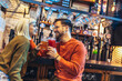 © Mediteraneo - Smiling young couple at the bar with different varieties of craft beers toasting