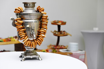 Wall Mural - Traditional Russian samovar with a bunch of bagels in white, light room