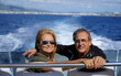 heterosexual couple on a boat in the sea looking at camera. Valentine's Day