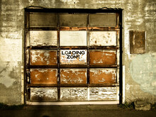 View Of An Old Garage Door And Loading Zone Sign In Seattle, Washington.