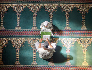 Wall Mural - Muslim pray, child or man in praying with Quran for peace, mindfulness or support from Allah in holy mosque. Top view, Islamic kid or person studying or praying to help worship God on Ramadan Kareem