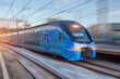 © aapsky - Electric passenger train drives at high speed among urban passenger station.