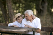 © Maria - Happy senior man Grandfather with cute little boy grandson playing in forest