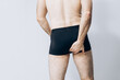 Beautiful male ass. The man is standing with his back to the camera. buttocks of a man in black shorts