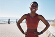 © C Malambo/peopleimages.com - Fitness, black woman and portrait of a runner by the sea with happiness and smile training. Relax, happy and workout of a athlete doing sport, marathon and exercise ready for cardio running