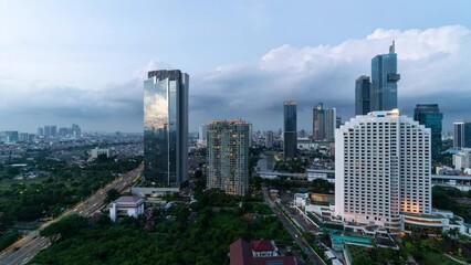 Wall Mural - Jakarta, Indonesia:  Day to night time lapse of the sunset over the modern Jakarta downtown district skyline with skyscrapers and luxury hotels in Indonesia capital city