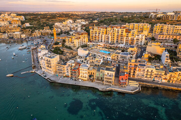 Wall Mural - Marsaskala village and seascape, Malta at sunrise. Aerial Drone view