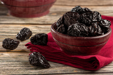 Sticker - Bowl with prunes on the table.