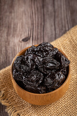 Wall Mural - Bowl with prunes on the table.