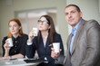 © Branimir - Business people talking and drinking coffee during a break during a meeting