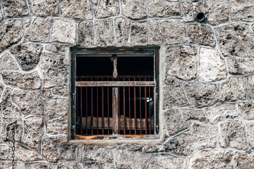 Wall Mural - old wooden window in stone wall