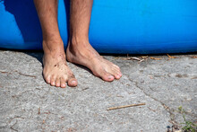 Barefoot Dirty Male Feet On The Hard Surface Of The Ground