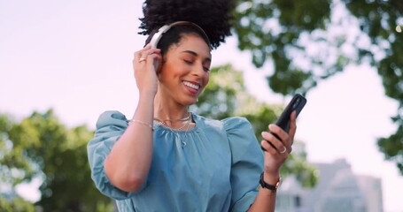 Wall Mural - Music, phone and headphones, woman in park happy and excited while dancing in garden trees. Technology, smartphone and dance, happy woman enjoying streaming service or free internet radio station.