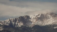 Slow pan of snow covered mountain Pike's Peak Colorado
