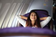 © sittinan - Traveling and Business concept,woman sitting near windows on airplane during flight