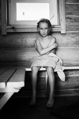 a little girl indulges in a steam room in the village with her grandmother. the child came to his gr