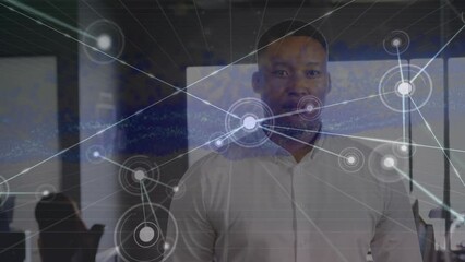 Poster - Animation of biracial businessman standing in office, dots connected with lines and abstract pattern