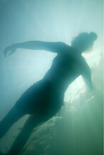Underwater Image Of Female Floating On The Surface Of A Lake, SC.