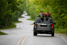 Car Transporting Kayaks On Winding Highway, Northport, Wisconsin, USA