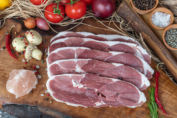 Raw steak with spices. Organic red raw steak sirloin against a background.