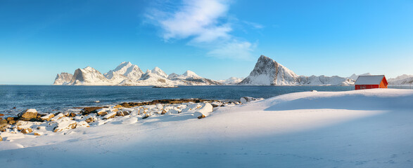 Wall Mural - Picturesque winter view on Vetvagoy coastline seen from Storsandnes beach in the morning.