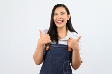 Portrait Asian young woman in waitress uniform with thumb up posture