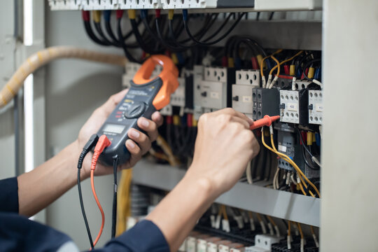 electrician engineer work tester measuring voltage and current of power electric line in electical c