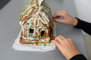 Kids with gingerbread house, A teenage girl is eating a gingerbread house