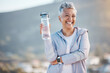 Fitness, happy or old woman with water bottle in nature to start training, exercise or hiking workout in New Zealand. Portrait, liquid or healthy senior person smiles with pride, goals or motivation