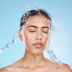 Canvas Print - Woman, washing face or water splash skincare on blue background studio in healthcare wellness, Brazil bathroom hygiene or self care grooming. Beauty model, water drop or facial cleaning in wet shower