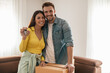 © ivanko80 - Smiling couple unpacking boxes in new home