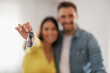 © ivanko80 - Caucasian couple show keys buy or rent first shared home