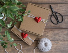 Valentine's Day Gift Wrapping. Kraft Gift Boxes Decorated With Red Hearts