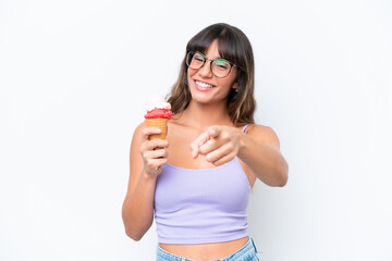 Canvas Print - Young caucasian woman with a cornet ice cream over isolated white background pointing front with happy expression