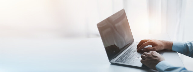 A business man is checking company financial documents and using a laptop to talk to the chief financial officer through a messaging program. Concept of company financial management.
