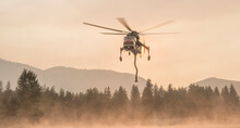 Firefighting Helicopter Filling Up With Water From Lake, Mazama, Washington State, USA