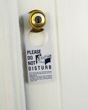 Please Do Not Disturb' Sign Hanging On A Doorknob.