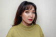 © Reezky - A beauty cheerful face of Asian young model wearing green top. Skincare beauty facial treatment, spa, female health concept.